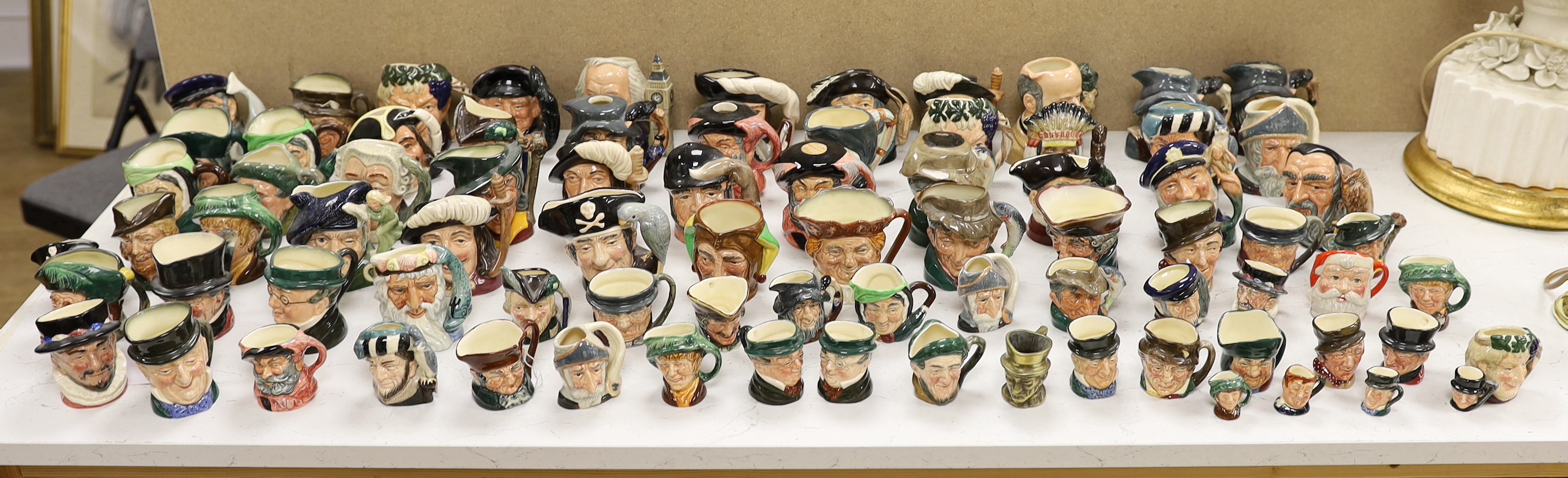 A large collection of Doulton character jugs including the Three Musketeers and Bacchus, largest 10cm high